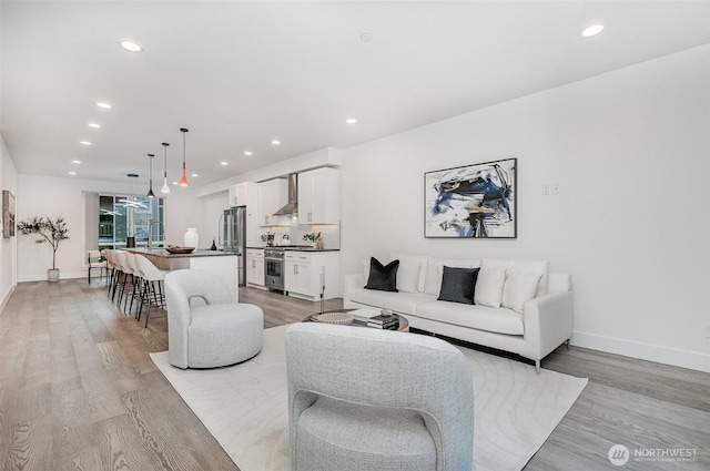 7731 NE 175th St Unit 102, Kenmore, WA 98028 - living room featuring light wood-style flooring and recessed lighting