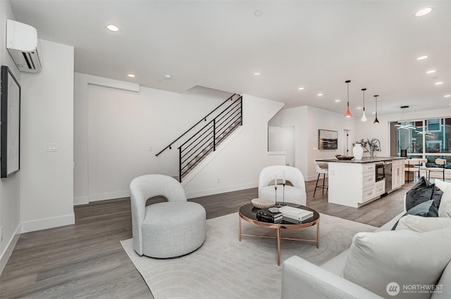 7731 NE 175th St Unit 102, Kenmore, WA 98028 - living area featuring an AC wall unit, stairs, wood finished floors, and recessed lighting