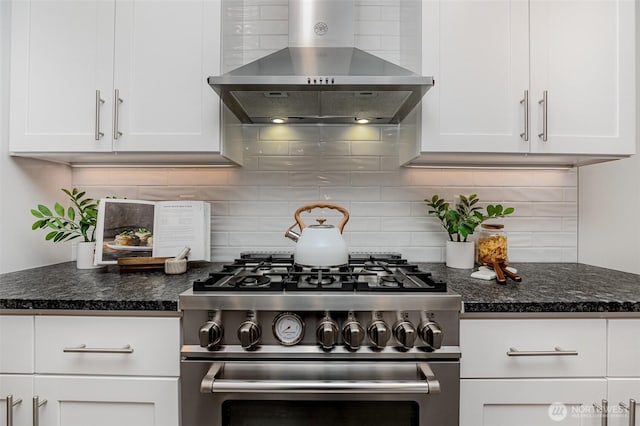 7731 NE 175th St Unit 102, Kenmore, WA 98028 - kitchen featuring wall chimney range hood, high end stainless steel range oven, white cabinets, and tasteful backsplash