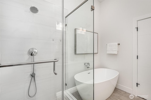 7731 NE 175th St Unit 102, Kenmore, WA 98028 - full bath with a stall shower and a freestanding tub