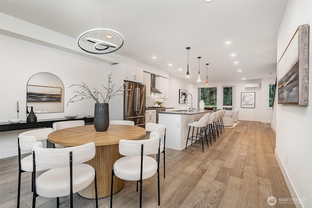 7731 NE 175th St Unit 102, Kenmore, WA 98028 - dining space featuring recessed lighting, light wood finished floors, and a wall unit AC