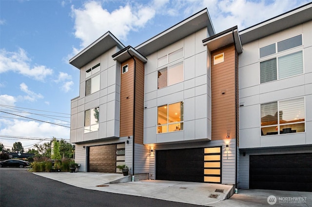 7731 NE 175th St Unit 102, Kenmore, WA 98028 - view of front of property with an attached garage and driveway