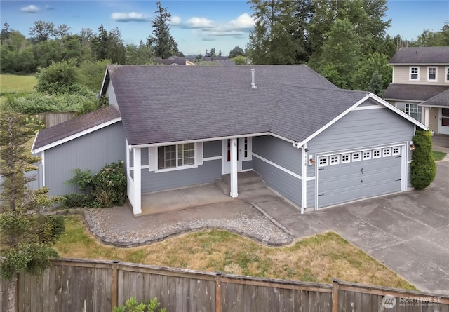1318 130th St E, Tacoma, WA 98445 - ranch-style house with a shingled roof, an attached garage, and driveway