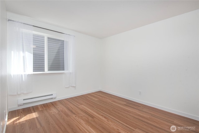 1000 NE 88th St Unit 303, Seattle, WA 98115 - unfurnished room featuring a baseboard heating unit and wood finished floors
