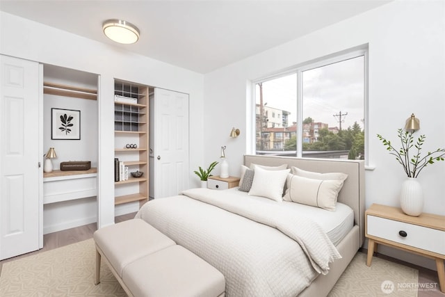 1000 NE 88th St Unit 303, Seattle, WA 98115 - bedroom with two closets and light wood-style floors