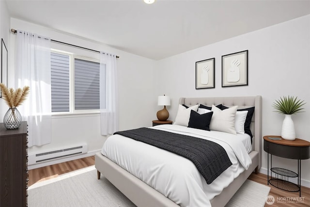1000 NE 88th St Unit 303, Seattle, WA 98115 - bedroom with a baseboard heating unit and wood finished floors