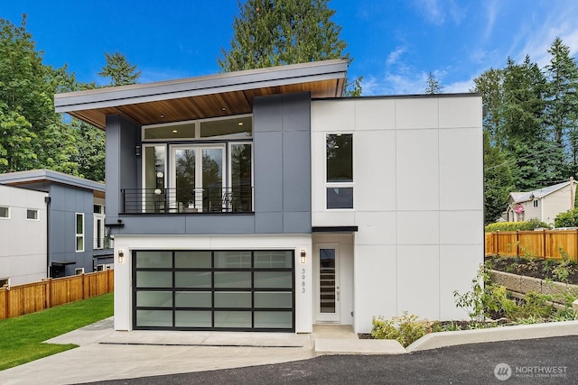 3983 162nd Pl SE, Bellevue, WA 98006 - modern home featuring a balcony, driveway, an attached garage, and stucco siding