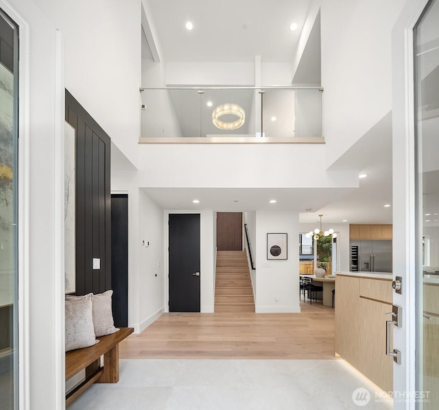 3983 162nd Pl SE, Bellevue, WA 98006 - foyer entrance featuring a towering ceiling, light wood-type flooring, a chandelier, stairs, and recessed lighting