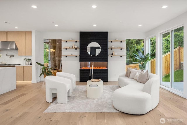 3983 162nd Pl SE, Bellevue, WA 98006 - living room with recessed lighting, light wood-type flooring, and a multi sided fireplace