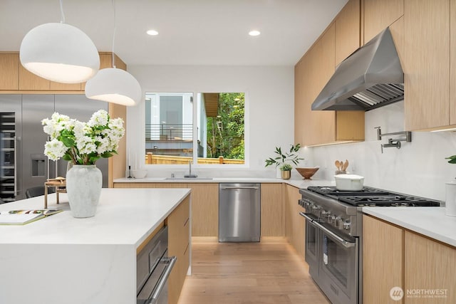 3983 162nd Pl SE, Bellevue, WA 98006 - kitchen featuring range hood, stainless steel appliances, modern cabinets, light countertops, and light wood-style flooring