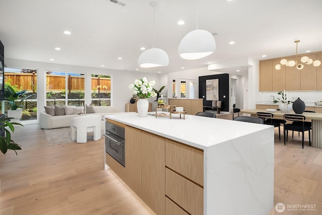 3983 162nd Pl SE, Bellevue, WA 98006 - kitchen featuring stainless steel oven, light brown cabinets, open floor plan, recessed lighting, and a kitchen island
