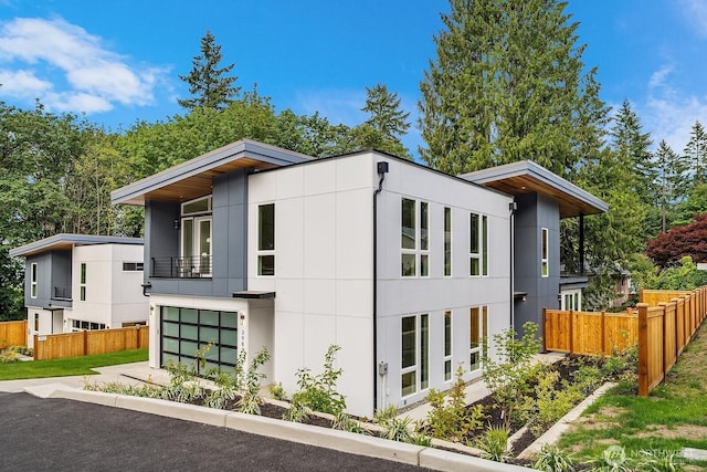 3983 162nd Pl SE, Bellevue, WA 98006 - view of home's exterior with a balcony, a garage, and stucco siding