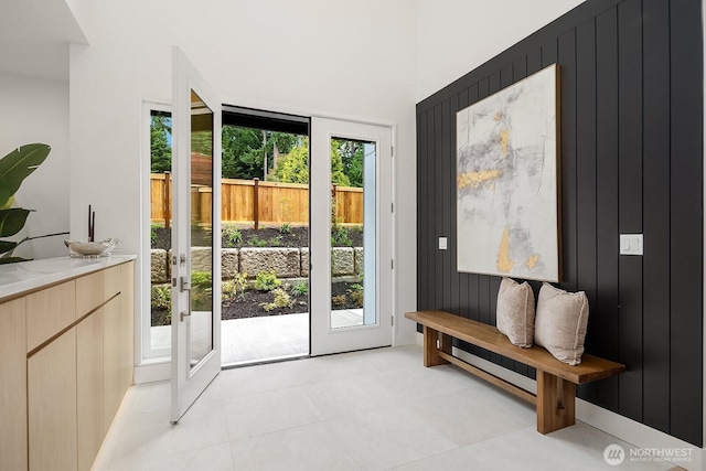 3983 162nd Pl SE, Bellevue, WA 98006 - doorway to outside with french doors, light tile patterned floors, and wooden walls