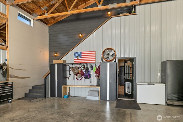 1712 Nelson Siding Rd, Cle Elum, WA 98922 - garage featuring freestanding refrigerator, wood walls, and white refrigerator