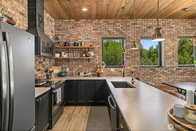 1712 Nelson Siding Rd, Cle Elum, WA 98922 - kitchen featuring appliances with stainless steel finishes, wood ceiling, dark cabinetry, brick wall, and light countertops