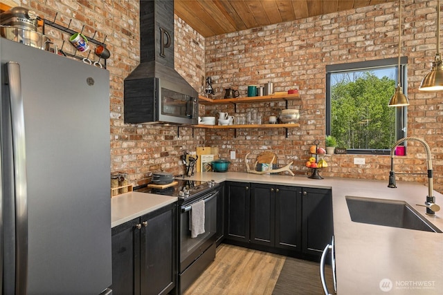1712 Nelson Siding Rd, Cle Elum, WA 98922 - kitchen with freestanding refrigerator, electric range, brick wall, dark cabinets, and wood ceiling