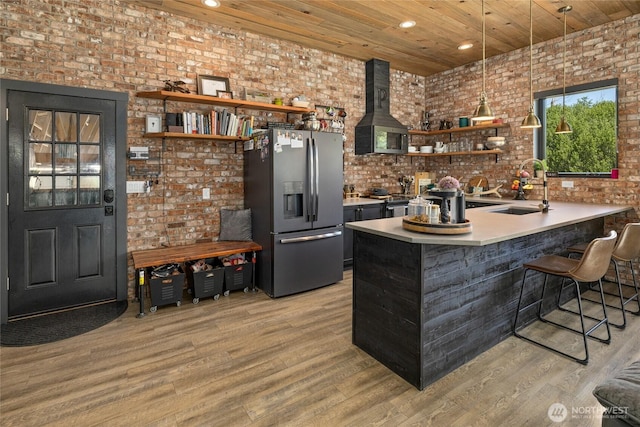 1712 Nelson Siding Rd, Cle Elum, WA 98922 - bar area with stainless steel fridge with ice dispenser, range hood, brick wall, light wood-type flooring, and wooden ceiling