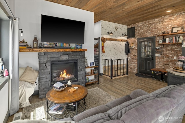 1712 Nelson Siding Rd, Cle Elum, WA 98922 - living room featuring wooden ceiling, a fireplace, wood finished floors, and brick wall