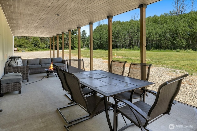 1712 Nelson Siding Rd, Cle Elum, WA 98922 - view of patio / terrace with outdoor dining area, a wooded view, and an outdoor living space with a fire pit
