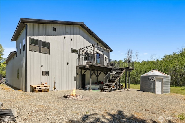 1712 Nelson Siding Rd, Cle Elum, WA 98922 - rear view of house featuring stairway, a deck, a storage shed, and an outdoor fire pit