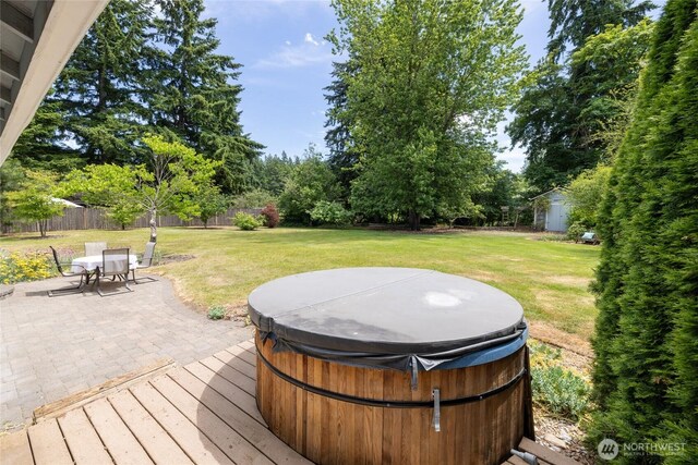 16325 Tareyton Ln SE, Yelm, WA 98597 - deck with a hot tub, a fenced backyard, a patio area, and a storage shed