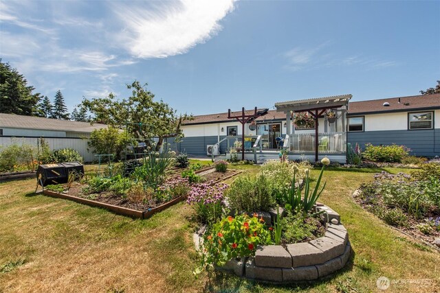 516 E Willow St, Sequim, WA 98382 - back of property featuring a vegetable garden, a yard, a pergola, and a deck