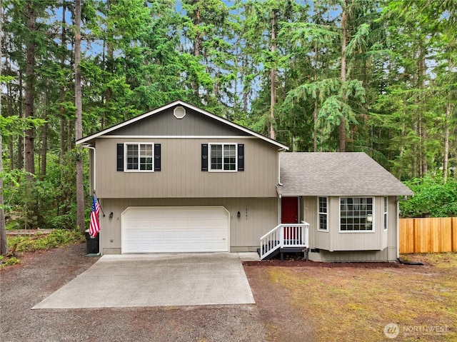 18401 Rampart Dr SE, Yelm, WA 98597 - tri-level home featuring concrete driveway, roof with shingles, and an attached garage