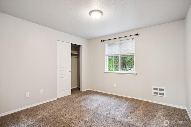 18401 Rampart Dr SE, Yelm, WA 98597 - unfurnished bedroom with carpet floors, a closet, and a textured ceiling