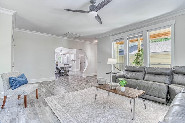 87 N Mary Ave, East Wenatchee, WA 98802 - living area with arched walkways, ornamental molding, a ceiling fan, healthy amount of natural light, and light wood-style floors