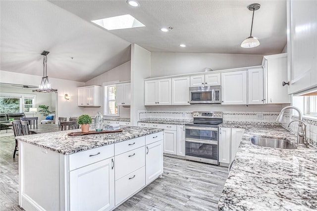 87 N Mary Ave, East Wenatchee, WA 98802 - kitchen with appliances with stainless steel finishes, lofted ceiling, white cabinets, a textured ceiling, and light stone counters