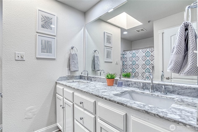 87 N Mary Ave, East Wenatchee, WA 98802 - full bathroom with a textured wall, a skylight, and double vanity