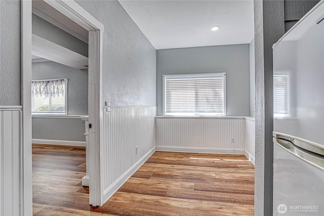 87 N Mary Ave, East Wenatchee, WA 98802 - empty room with wood finished floors, a textured wall, and wainscoting