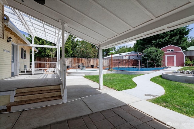 87 N Mary Ave, East Wenatchee, WA 98802 - fenced backyard with a storage unit, a patio area, and a wooden deck