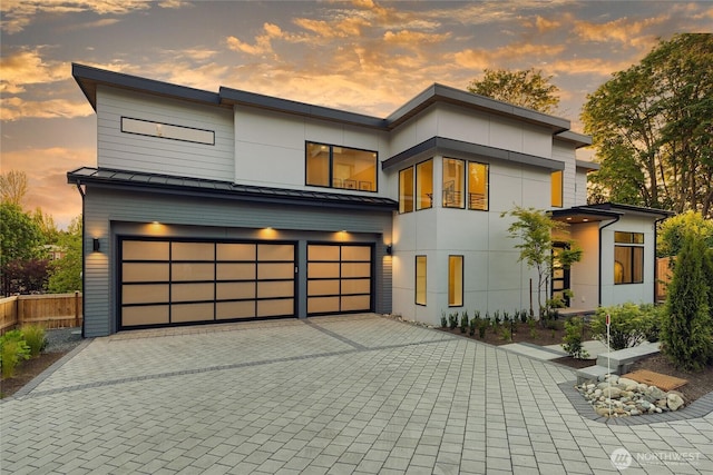 10204NE 43rd St, Kirkland, WA 98033 - contemporary home featuring a standing seam roof, an attached garage, decorative driveway, and a metal roof