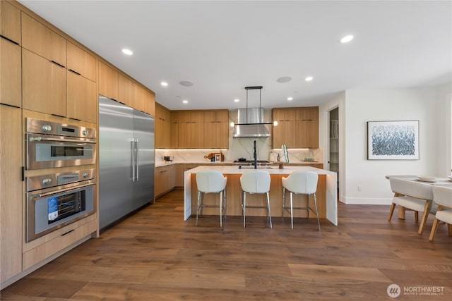 10204NE 43rd St, Kirkland, WA 98033 - kitchen featuring appliances with stainless steel finishes, modern cabinets, a breakfast bar, light countertops, and recessed lighting