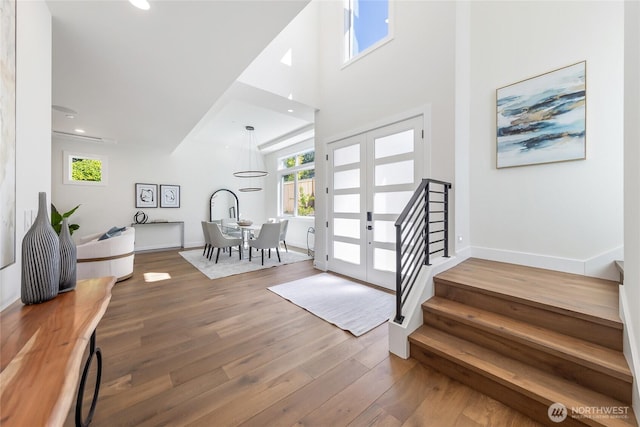 10204NE 43rd St, Kirkland, WA 98033 - foyer entrance with stairway, wood finished floors, plenty of natural light, a high ceiling, and recessed lighting