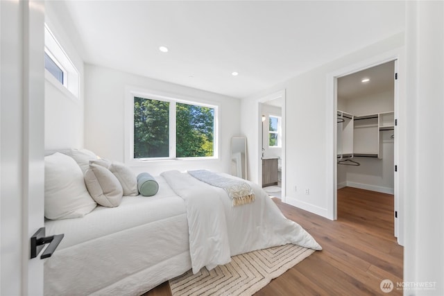 10204NE 43rd St, Kirkland, WA 98033 - bedroom featuring wood finished floors, a walk in closet, recessed lighting, ensuite bath, and a closet
