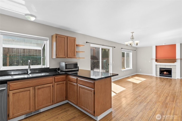 26822 27th Ave S, Kent, WA 98032 - kitchen featuring appliances with stainless steel finishes, a chandelier, open floor plan, light wood-type flooring, and a peninsula