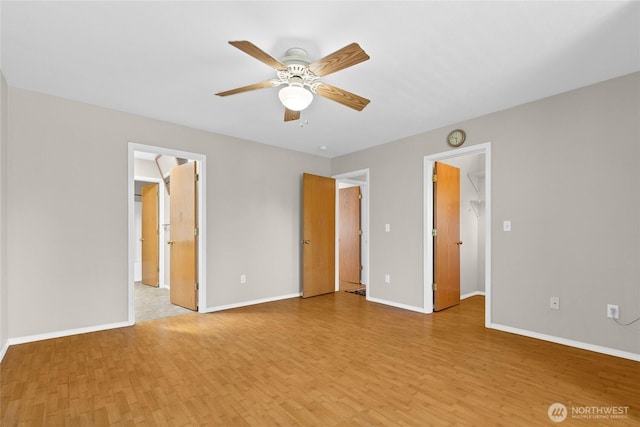 26822 27th Ave S, Kent, WA 98032 - unfurnished bedroom with light wood-style floors, a walk in closet, a ceiling fan, and a closet
