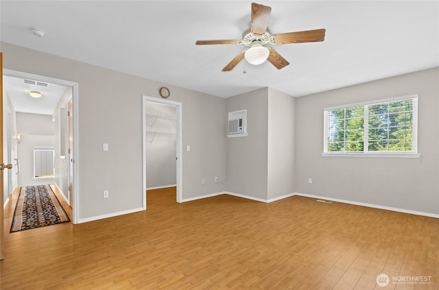 26822 27th Ave S, Kent, WA 98032 - unfurnished bedroom with light wood-style floors, a spacious closet, a wall unit AC, a ceiling fan, and a closet