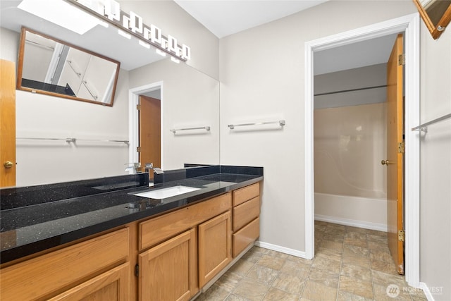 26822 27th Ave S, Kent, WA 98032 - full bathroom with vanity, stone finish flooring, and washtub / shower combination
