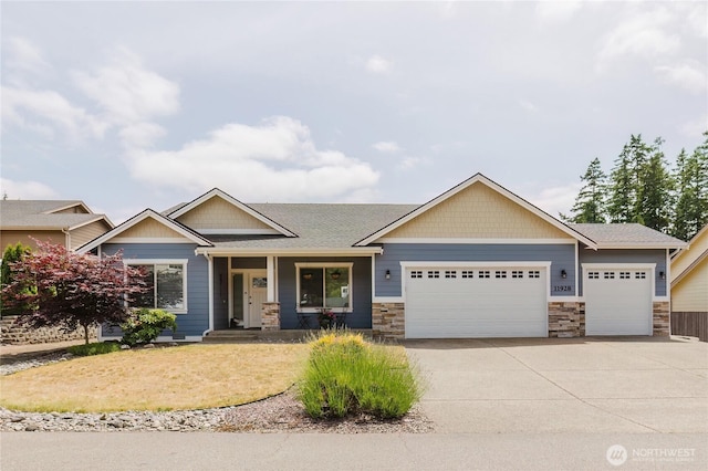11928 Mayfair Ave SW, Port Orchard, WA 98367 - craftsman-style house with an attached garage, stone siding, concrete driveway, a porch, and roof with shingles