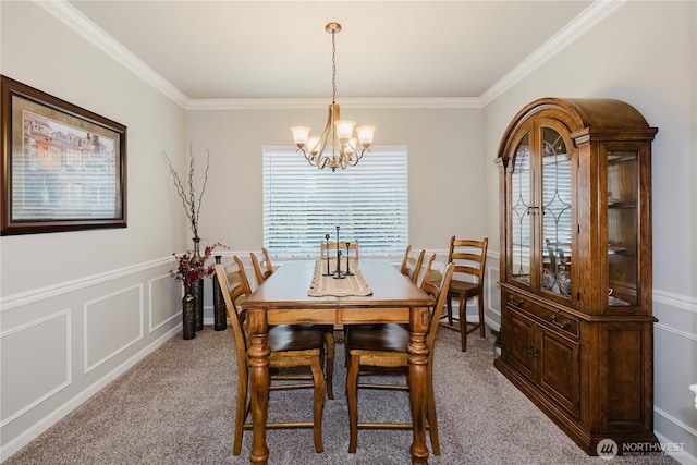 11928 Mayfair Ave SW, Port Orchard, WA 98367 - dining area with a chandelier, light colored carpet, crown molding, wainscoting, and a decorative wall
