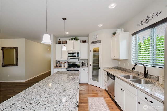 11928 Mayfair Ave SW, Port Orchard, WA 98367 - kitchen featuring appliances with stainless steel finishes, light wood-style flooring, white cabinets, and recessed lighting