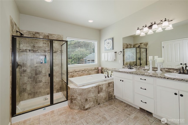 11928 Mayfair Ave SW, Port Orchard, WA 98367 - bathroom featuring a garden tub, double vanity, and a stall shower