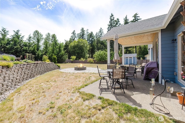 11928 Mayfair Ave SW, Port Orchard, WA 98367 - view of yard featuring a fire pit, a storage unit, a patio area, and outdoor dining space