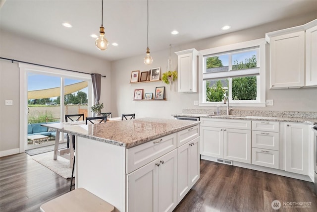 204 Regent Ct, Nooksack, WA 98276 - kitchen featuring dark wood-style flooring, white cabinetry, recessed lighting, a center island, and pendant lighting