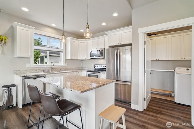 204 Regent Ct, Nooksack, WA 98276 - kitchen with washer / clothes dryer, appliances with stainless steel finishes, white cabinetry, dark wood finished floors, and recessed lighting