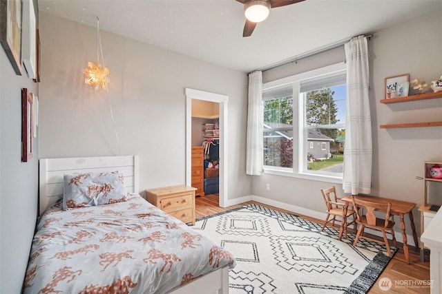 204 Regent Ct, Nooksack, WA 98276 - bedroom with a spacious closet, wood finished floors, a closet, and a ceiling fan