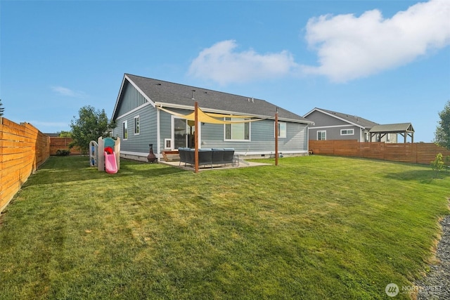 204 Regent Ct, Nooksack, WA 98276 - back of house with a fenced backyard, a patio, board and batten siding, and an outdoor living space